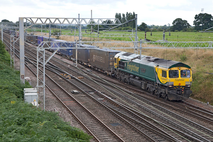 66528, 11.57 Daventry-Coatbridge (4S44), Casey bridge, Basford Hall Junction 
 The 4S44 11.57 Daventry to Coatbridge Freightliner is about to pass under Casey bridge just south of Crewe's Basford Hall by 66528 'Madge Elliot MBE - Borders Railway Opening 2015'. It's a shame that I could not get a lower vantage point at this location to avoid the cursed wires cutting through the locomotive, oh. the perils of photographing under 25kV catenary! 
 Keywords: 66528 11.57 Daventry-Coatbridge 4S44 Casey bridge Basford Hall Junction