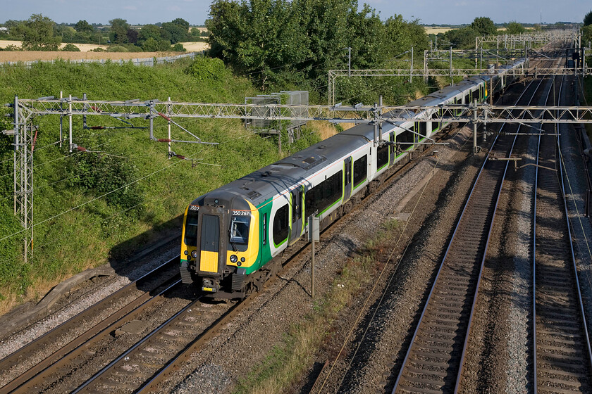 350267 & 350247, LM 17.24 London Euston-Crewe (2U99), Victoria bridge 
 The superb evening light at Victoria bridge just south of Roade in Northamptonshire makes even a lowly London Midland Desiro look half reasonable! 350267 and 350247 are now six years old having been delivered in 2008 and are seen here working the 2U99 17.24 Euston to Crewe service. 
 Keywords: 350267 350247 17.24 London Euston-Crewe 2U99 Victoria bridge London Midland Desiro