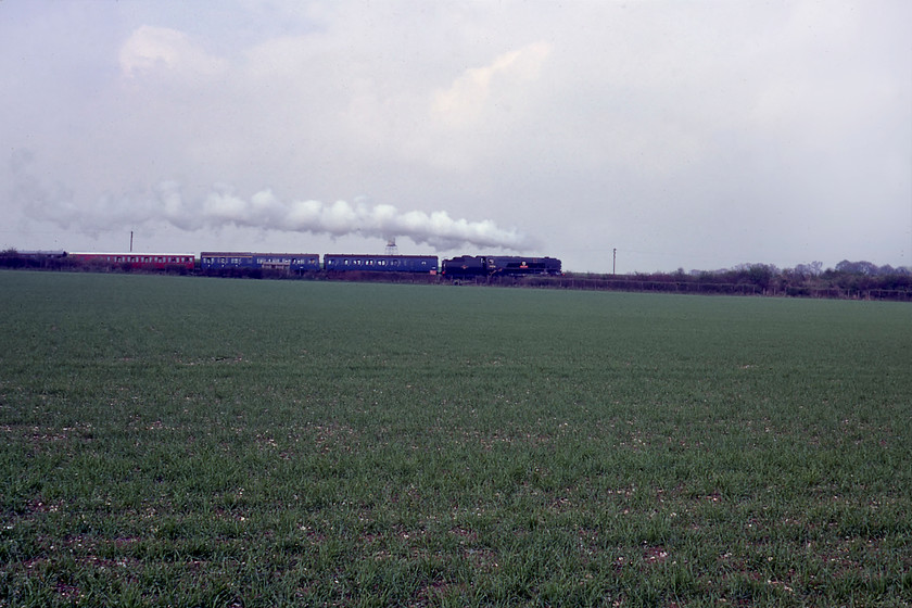 34016, 16.00 Alresford-Ropley, Bishop's Sutton SU615320 
 Looking across a field of spring wheat 34016 'Bodmin' leads the 16.00 New Alresford to Ropley train. The photograph is taken from a green lane near the village of Bishop's Sutton on our longish walk back to Alresford in order to get the coach back home. I like the flat and straight exhaust in this photograph the wind obviously coming gently from the east. 
 Keywords: 34016 16.00 Alresford-Ropley Bishop's Sutton SU615320 Bodmin Watercress Line