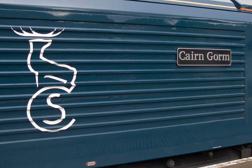 Nameplate, 67004, CS 21.16 London Euston-Inverness, Fort-William & Aberdeen sleeper (1S25 & 1Y11), Crianlarich station 
 With Caledonian Sleeper, operated by Serco, having taken over the operation of the Highland and Lowland services less than six months ago, they have concentrated on painting their locomotives with no stock yet to receive the new teal paint scheme. At Crianlarich station, the nameplate, and smart CS logo is seen on the side of 67004 'Cairn Gorm'. Looking at the deeply ribbed side panel of the Class 67 I suspect the application of the CS vinyl logo would have proved somewhat tricky! 
 Keywords: Nameplate 67004 21.16 London Euston-Inverness Fort-William Aberdeen sleeper 1S25 1Y11 Crianlarich station Cairn Gorm Caledonian Sleeper