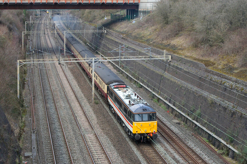 86101, 14.10 Wembley Yard-Crewe HS (5Z65, 56L), Roade cutting 
 Dead in tow on the rear of the 14.10 Wembley Yard to Crewe HS 86101 Sir William Stanier FRS is seen as the train passes through Roade cutting. 86101 was one of a pair (the other being 87002) that were sold to LSL back in 2019 by Electric Traction Limited following the ending of their contract to haul the Caledonian Sleeper Mk. III stock in and out of Euston from Wembley Yard. It is good that this decision was made rather than the alternative one of putting them into storage and then for them to possibly never work on the network again! 
 Keywords: 86101 14.10 Wembley Yard-Crewe HS 5Z65 Roade cutting LSL Locomotive Services LTD Sir William Stanier FRS