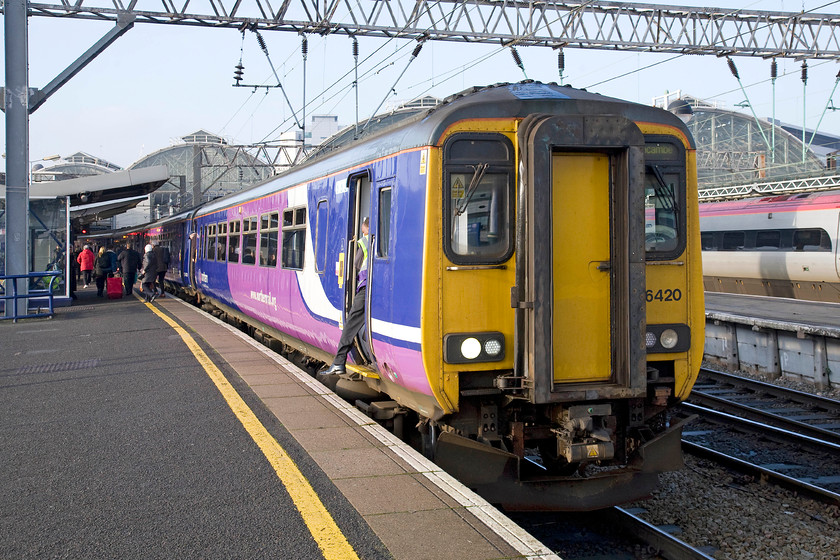 156420, NT 11.23 Southport-Manchester Airport (2A10), Manchester Piccadilly station 
 A crew change is taking place at Manchester Piccadilly as the driver steps down from 156420. The service has paused with the 11.23 Southport to Manchester Airport working. 
 Keywords: 156420 11.23 Southport-Manchester Airport 2A10 Manchester Piccadilly station