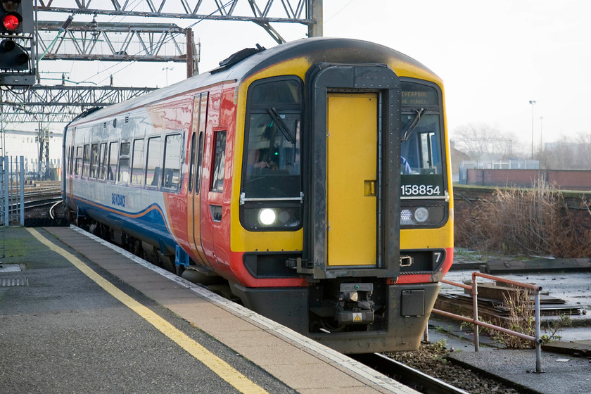 158854, EM 07.57 Norwich-Liverpool Lime Street (1R70), Manchester Piccadilly station 
 EMT's 158884 arrives for its stop at Manchester Piccadilly station with the 07.57 Norwich to Liverpool Lime Street. This 1R70 working is a 237 miles end to end journey that crosses the country from east to west. These services used to be formed of a good solid set of stock hauled by a locomotive up front, often a class 31. The 158s are not in quite the same league as that but are at least of the modern day equivalents they are they are among the more comfortable. 
 Keywords: 158854 07.57 Norwich-Liverpool Lime Street 1R70 Manchester Piccadilly station