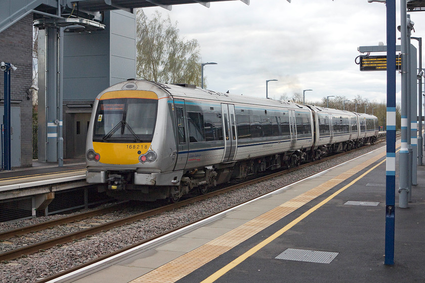 168218, 13.30 London Marylebone-Oxford Parkway (1T35), Bicester Village station 
 168218 leaves Bicester Village station with the 13.30 Marylebone to Oxford Parkway service. It is passing under the huge footbridge that has been installed to carry the huge numbers of visitors to the adjacent Bicester Village retail outlet. This is very popular with foreign visitors who can now travel rapidly from London arriving in less than an hour. 
 Keywords: 168218 13.30 London Marylebone-Oxford Parkway 1T35 Bicester Village station