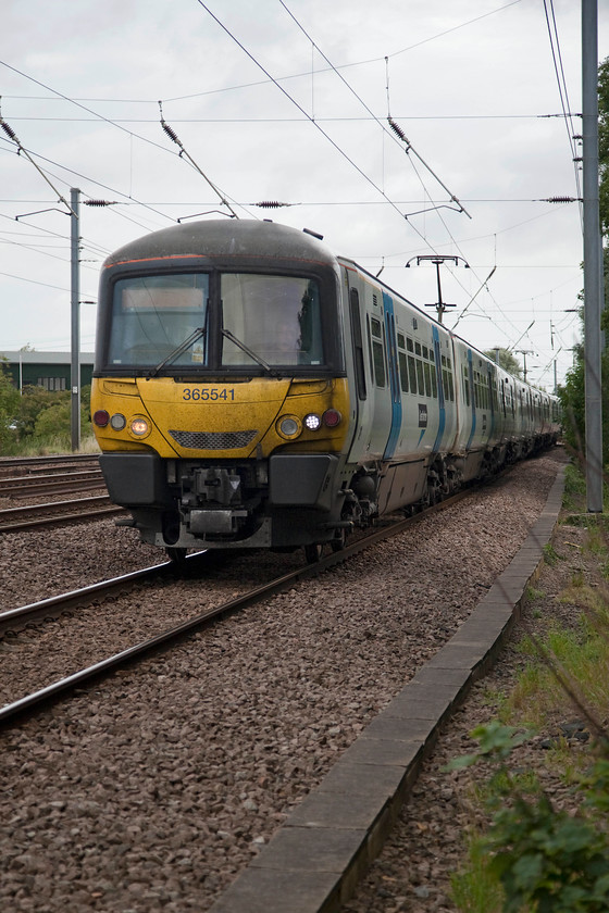 365541, GN 08.46 Peterborough-London Kings Cross (1P53, 8L), Gills Crossing 
 Taken from the refuge of a fence at a public crossing 365541 passes Offord Cluny with the 08.46 Peterborough to London King's Cross. Even though I am safe and perfectly legal taking this shot, I often wonder how it might look to a driver as he appears around the corner? 
 Keywords: 365541 1P53 Gills Crossing