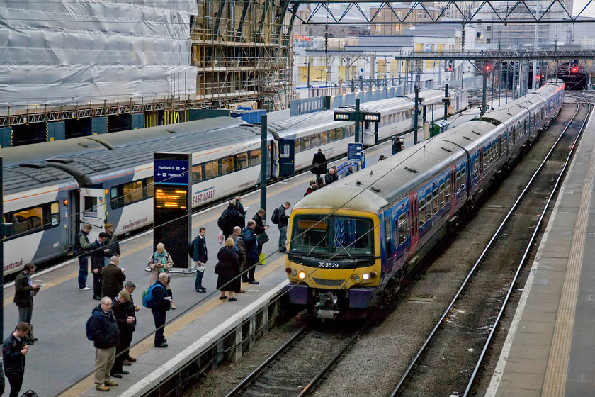 365529, FC 16.34 Welwyn Garden City-London King's Cross ECS (3YO2), London King's cross Station 
 With the station announcer already apologising for the late departure of their train the passengers on platform six watch as their train arrives working the 16.34 from Welwyn Garden City. 365529 will have to be turned around pretty rapidly in order to get the passengers away with the minimum of fuss. These reliable Networker family units dating from the mid-1990s are about to undergo a refurbishment programme but will leave this route in the coming few years to be replaced by new units. 
 Keywords: 365529 16.34 Welwyn Garden City-London King's Cross ECS 3YO2 London King's Cross Station