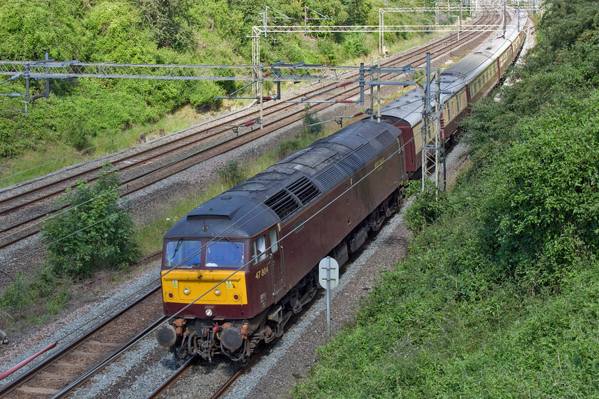 47804, 09.02 London Euston-Milton Keynes (1Z60, 4L), Victoria bridge 
 With the driving crew having changed ends at Northampton station the 09.02 Euston to Milton Keynes GP special heads south past Victoria bridge near Roade. The extra thirty two miles to and from Northampton would give the premium fare paying passengers extra time to enjoy their sumptuous breakfast aboard the fine rake of restored Pullman cars. 
 Keywords: 47804 09.02 London Euston-Milton Keynes 1Z60 Victoria bridge