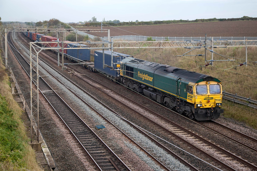 66589, 03.35 Garston-London Gateway (4L52), Castlethorpe SP790453 
 66589 heads the 4L52 03.35 Garston to London Gateway Freightliner along the up slow line just north of Castlethorpe in Buckinghamshire. Another shot taken 'through' the wires that is far from perfect but when access to the lineside at lower levels is so limited then it has to do! 
 Keywords: 66589 03.35 Garston-London Gateway 4L52 Castlethorpe SP790453