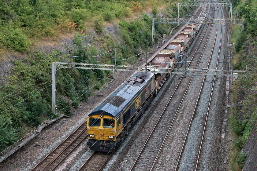 66703, 10.53 Hanslope Junction-Bescot (6G50, 4E), Roade cutting 
 A relatively short infrastructure working passes through Roade cutting lead by GBRf's 66703 'Doncaster PSB 1981-2003'. The 6G50 10.53 Hanslope Junction to Bescot is composed of five discharge ballast wagons and three flats with used track panels on them. I am not sure where exactly the panels were removed but I think that they were from the up or down fast lines somewhere between Bletchley and Hanslope Junction. 
 Keywords: 66703 10.53 Hanslope Junction-Bescot 6G50 Roade cutting GBRF Doncaster PSB 1981-2003