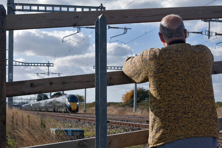 Andy & 800024 & 800021, GW 14.30 Bristol Temple Meads-London Paddington (1A24, RT), Grove foot crossing SU393911 
 Andy takes in the scene at Grove a few miles west of Didcot watching 800024 and 800021 work the 14.30 Bristol to Paddington express service. He is in the safety of a corral at one of the last few remaining flat foot crossings on the GWML. It is a rare treat to be able to stand in such an unrestricted position so close to trains passing at up to one hundred and twenty-five miles per hour but for how long this will remain one wonders? 
 Keywords: Andy 800024 800021 14.30 Bristol Temple Meads-London Paddington 1A24 Grove foot crossing SU393911 GWR IET