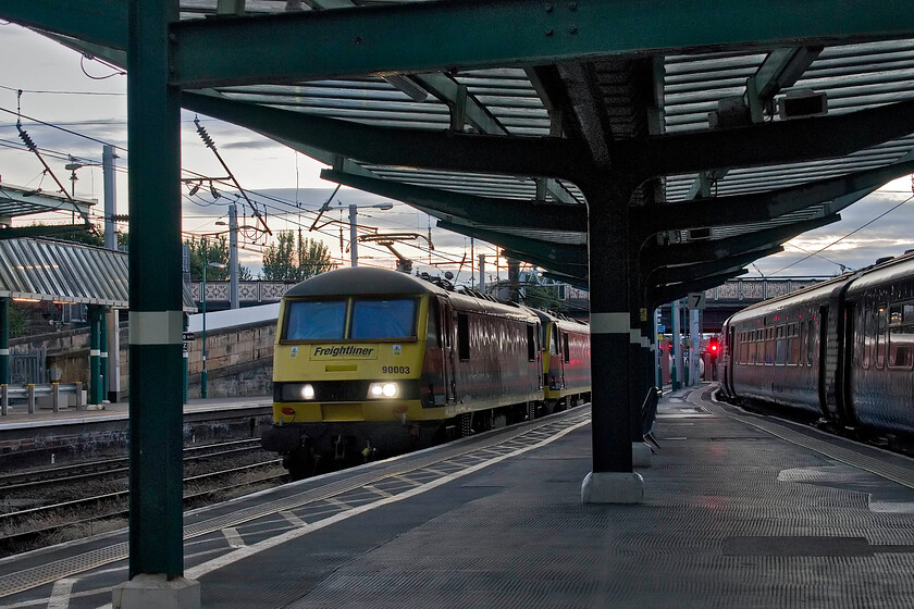 90003 & 90011, 19.36 Coatbridge FLT-Crewe Basford Hall (4M86, 3E), Carlisle station 
 It's ten minutes to ten on the day before the longest day so a reasonable photograph can still be taken of a moving train here at Carlisle. Unfortunately, the 4M86 19.36 Coatbridge to Basford Hall caught me unawares so the framing of both 90003 and 90011 is not perfect between the canopy supports. 
 Keywords: 90003 & 90011, 19.36 Coatbridge FLT-Basford Hall (4M86, 3E), Carlisle station