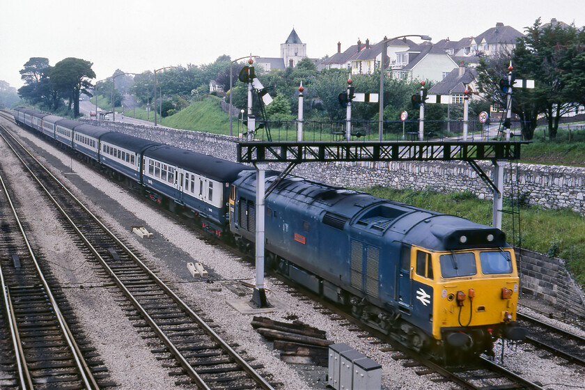 50018, 14.25 London Paddington-Plymouth (1B02), Aller Junction 
 The final picture of the thirty-two that made the cut (there were a few that did not make it out of the reject box) from my superb day out with David and Paul shows 50018 'Resolution' getting up to speed at Aller Junction leading the 1B02 14.25 Paddington to Plymouth service. As soon as the train pulls away and clear of the junction it starts the assault on the fearsome Dainton bank so drivers were always keen to get a clear signal on leaving Newton Abbot in order to build up some speed. A class fifty should have plenty of power to haul a mixture of Mk. II stock along with a Mk. I Buffet/Restaraunt and the ubiquitous Mk. I BG tagged on at the rear up and over the gradients of Devon even if the air conditioning fitted to some of the stock would sap some of its power. 
 Keywords: 50018 14.25 London Paddington-Plymouth 1B02 Aller Junction Resolution