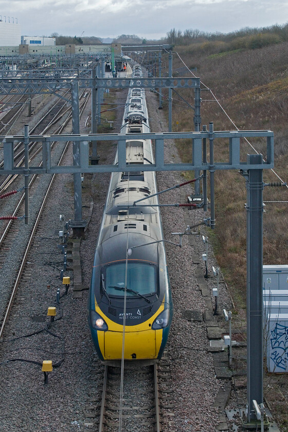 390122, VT 12.16 London Euston-Edinburgh Waverley (9S70, 54L), Loughton Redway bridge, Milton Keynes 
 390122 'Penny the Pendolino' leaves Milton Keynes station, seen in the background, working the 9S70 12.16 Euston to Edinburgh Anglo-Scottish service. At this stage in its journey all was going well that is until it reached Preston. According to RTT it sat at platform for nearly an hour eventually arriving at Waverley fifty-four minutes late. I hope that passengers on board were kept regularly informed as to what was happening, something that does not always happen as it should. 
 Keywords: 390122 12.16 London Euston-Edinburgh Waverley 9S70 Loughton Redway bridge Milton Keynes AWC Avanti West Coast Pendolino Penny the Pendolino