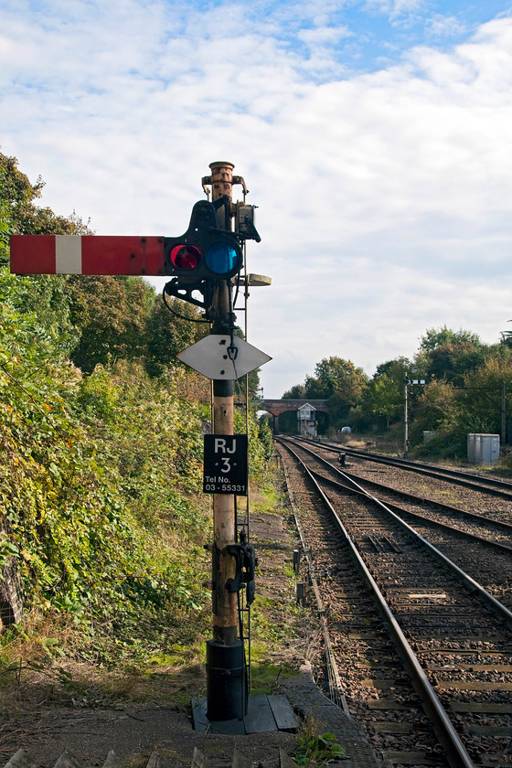 Up station starter signal, Reedham station 
 Get your picture while you can! Scenes such as this at Reedham station are set to change over the next couple of years as the Victorian era signalling is wiped away. Looking east from the end of Reedham station sees it up starter RJ3 (Reedham Junction 3) at danger. The signal box that controls the signal is seen in the distance just in front of the bridge. Another relic from past times is over in the trees to the far right, the station yard's loading gauge is still standing. 
 Keywords: Up station starter signal Reedham station