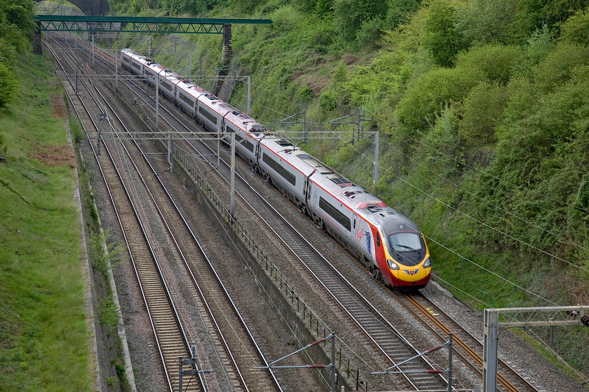 390002, VT 08.43 London Euston-Edinburgh (9S34), Roade cutting 
 390002 'Virgin Angel' passes through Roade cutting working the 9S34 08.43 Euston to Edinburgh service. This is my second picture of this Pendolino with its one-off blue angel vinyls on the nose and flanks just behind the driver's door. 
 Keywords: 390002 08.43 London Euston-Edinburgh 9S34 Roade cutting pendolino Virgin trains Virgin Angel