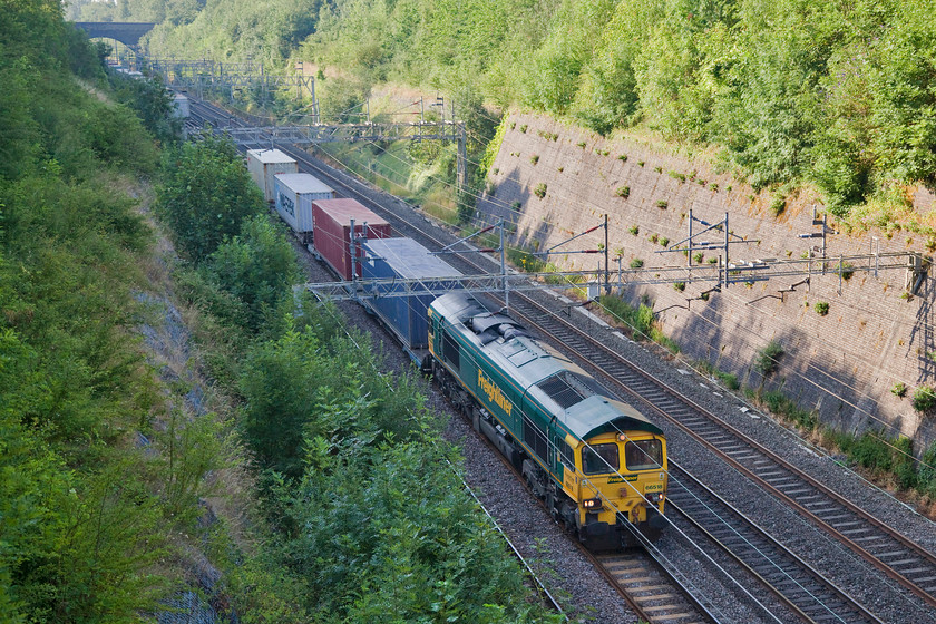 66518, 02.57 Felixstowe N-Garston FLT-(4M45), Roade Cutting 
 Completely in the shadows but a decent picture of a down train on the north to south WCML early on a summer's morning is difficult to get! 66518 leads the regular Saturdy morning 02.57 Felixstowe North to Garston Freightliner (4M45) through Roade Cutting. 
 Keywords: 66518 02.57 Felixstowe N-Garston FLT 4M45 Roade Cutting