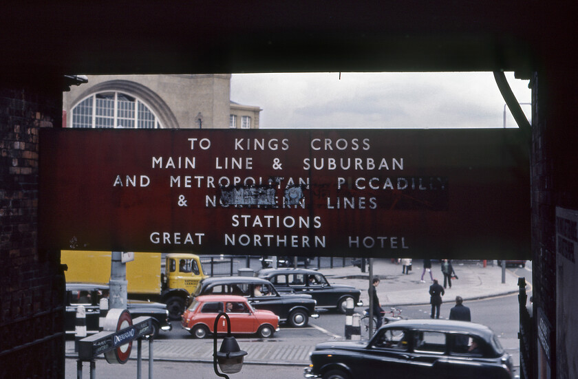 Enamel, St. Pancras station 
 On the reverse side of the sign seen in the previous photograph is some useful information for passengers arriving at St. Pancras station including where they might be staying for the night! Beyond the traffic at the traffic lights on Pancras Road that is waiting to get on to Euston Road is the unmistakable facade of King's Cross station. Amongst the inevitable FX4 taxis is a Mini and a vehicle that I am going make a strong link with to today's modern-day courier UPS. The yellow lorry is one of National Carriers' fleet that at this time was a state-owned arm of British Rail that delivered packets and parcels. Under the Thatcher government this was privatised in 1982 becoming National Carriers Roadline before settling on the name Lynx Express Delivery Network later shortened to just Lynx that also acquired Red Star Parcels. In 2005 the whole lot, then the largest independent delivery service in the UK, was bought by UPS. 
 Keywords: Enamel St. Pancras station