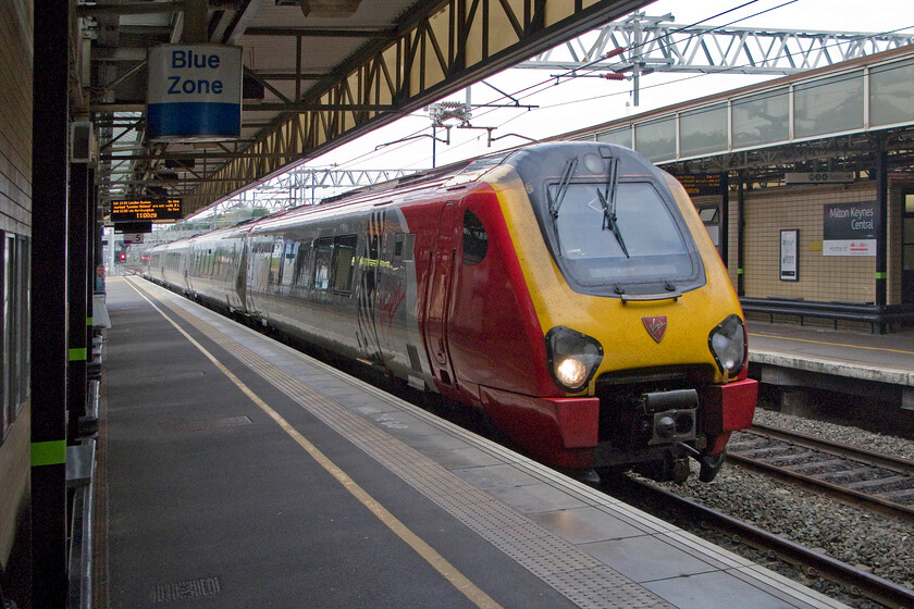 221143, VT 07.55 Holyhead-London Euston (1A20), Milton Keynes station 
 Of all the trains that we could have taken from Milton Keyes to Euston it just had to be a Voyager didn't it! 221143 ' Auguste Picard' arrives at Milton Keynes working the 1A20 07.55 Holyhead to Euston service. Never mind, at least my wife and I were only on this plastic glorified DMU for less than thrirty minutes! 
 Keywords: 221143 07.55 Holyhead-London Euston 1A20 Milton Keynes station Virgin West Coast Voyager Auguste Picard.