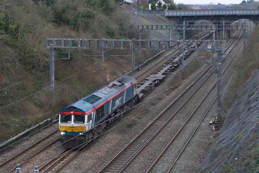 66747, 11.39 London Gateway-Hams Hall (4M47, 7E), Hyde Road bridge 
 The one-of Newell and Wright Transport liveried 66747 passes Roade leading the 4M47 11.39 London Gateway to Hams Hall service. Despite it being the early afternoon the light was absolutely dreadful on this, the first day of February with the camera struggling to produce a reasonably clean image. Both Photoshop and Neat Image had to work hard to process the image! 
 Keywords: 66747 11.39 London Gateway-Hams Hall 4M47 Hyde Road bridge