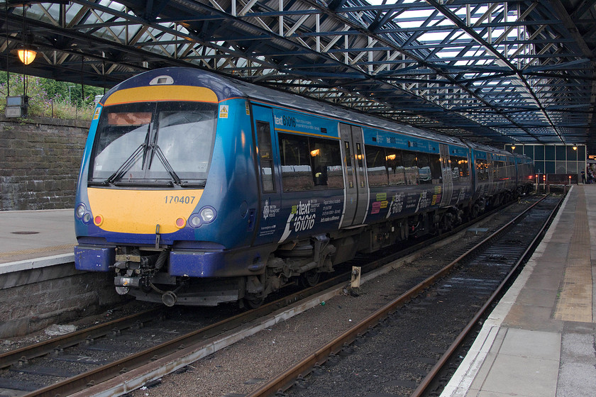 170407, SR 19.17 Markinch-Dundee ECS (5N79), Dundee station 
 Having arrived at Dundee station as the 5N79 ECS working from Markinch, 170407 had its engines shut down and then rested overnight at the station before working it first train the following morning. This unit, along with a number of other ScotRail class 170s, was adorned with graphics encouraging the public to report railway crime to the British Transport Police via a dedicated text and 'phone number. 
 Keywords: 170407 19.17 Markinch-Dundee ECS 5N79 Dundee station