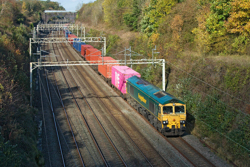 66542, 09.52 Lawley Street-Southampton MCT (4O38, 2L), Hyde Road bridge 
 In the last few days the autumn colours, which have been pretty conspicuous until now have really begun to warm up! Passing through Roade cutting 66542 is leading the 4O38 09.52 Lawley Street to Southampton Freightliner, a service that should have been hauled by a Class 70 much to the disappointment of one of my fellow photographers at this spot! Whilst it is a sunny scene, the foreground has just gone into full shadow just seconds before the train passed - sometimes it comes together! 
 Keywords: 66542 09.52 Lawley Street-Southampton MCT 4O38 Hyde Road bridge Freightliner