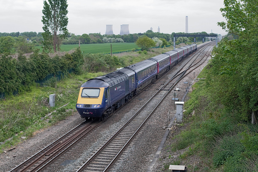 43162, GW 11.29 Swansea-London Paddington (1L55, RT), Steventon 
 A small mile long length of the GWML free of electrification masts serves as a reminder of how this line has looked for generations. Here, taken from the B4107 road bridge in Steventon, 43162 is seen powering at the rear of the 11.29 Swansea to Paddington. In the very distance the march of the masts can be seen and in the background the remaining cooling towers of Didcot's power station. 
 Keywords: 43162 1L55 Steventon