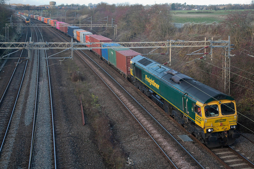 66598, 12.12 Lawley Street-London Gateway (4L46), Victoria bridge 
 66598 heads past Victoria bridge on the southern section of the WCML between Northampton and Milton Keynes leading the heavily loaded 4L46 12.12 Lawley Street to London Gateway Freightliner. The whole morning (when I could not get out) had been gloriously sunny, the moment I got the camera out for an hour, the sun went in behind a line of troublesome cloud! 
 Keywords: 66598 12.12 Lawley Street-London Gateway 4L46 Victoria bridge