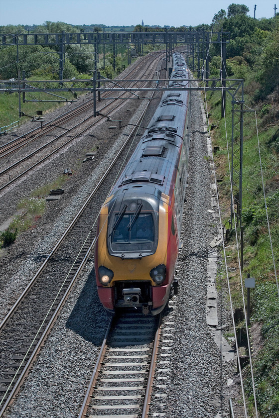 Class 221s, 11.43 London Euston-Preston (9P65, 7L), Ashton Road bridge 
 I am beginning to ramp up my photographing of Class 221 Voyagers on the WCML. This is not because I like them, in fact, the opposite is true, but their time working trains on the line is now limited. Like so many things on the railways their service to both Virgin and, more recently, Avanti West Coast will be lost in the sands of history. In their more common and double-manned formation, a pair of units head north about to pass under Ashton Road bridge near Roade working the 11.43 Euston to Preston. 
 Keywords: Class 221 11.43 London Euston-Preston 9P65 Ashton Road bridge Virgin Voyager Avanti West Coast