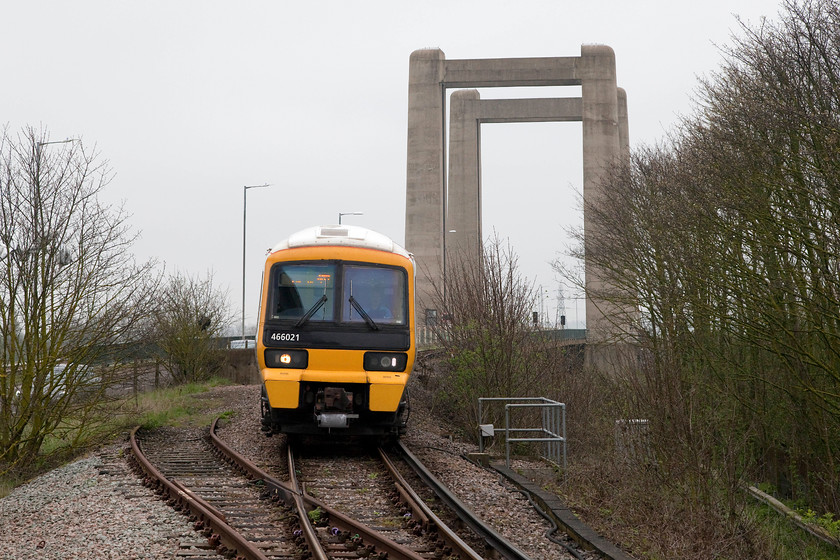 466021, SE 10.51 Sheerness-on-Sea-Sittingbourne (2D26, 1L), Swale station 
 With the 1960 built Swale vertical lifting bridge in the background Networker 466021 approaches Swale station with the 10.51 Sheerness to Sittingborune working. The bridge is a characteristic feature of the area and just out of site to the right is the Sheppey Crossing opened in 2006. This significantly eased the congestion on the old road and rail bridge. 
 Keywords: 466021 2D26 Swale station