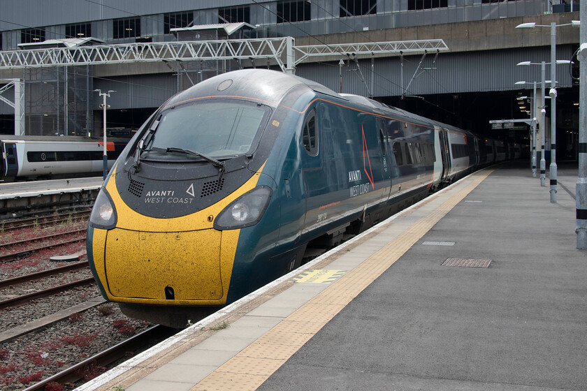 390134, VT 11.20 London Euston-Manchester Piccadilly (1H21, 2E), London Euston station 
 Our train back from London to Milton Keynes waits at Euston station. My wife and I travelled on 390134 'City of Lancaster' working the 1H21 11.20 service to Manchester. Taking just a shade under thirty minutes meant that my wife could not even take a nap something that she complained about but she also complains that the more usual London Northwestern services take too long; I will say no more! 
 Keywords: 390134 11.20 London Euston-Manchester Piccadilly 1H21 London Euston station Avanti West Coast Pendolino City of Lancaster