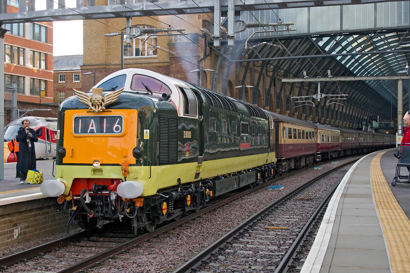 D9000, outward leg of The Edinburgh Christmas Market, 08.44 London King's Cross-Edinburgh Waverley (1Z46, 18L), London King's Cross station 
 Looking resplendent in its now familiar green livery and returning to its natural home D9000 'Royal Scots Grey' takes The Edinburgh Christmas Market charter away from King's Cross running as 1Z45. Looking at the exhausts it is clear that the locomotive is running on both engines meaning plenty of power will be in hand to get the train to York where 60007 'Sir Nigel Gresley' was to take over. Just as an aside, footage that I have seen of the train on arrival at York appears to show just one engine running so perhaps there was a problem en route or one was shut down as an economy measure. 
 Keywords: D9000 The Edinburgh Christmas Market 08.44 London King's Cross-Edinburgh Waverley 1Z46 London King's Cross station 55022 Royal Scots Grey Deltic