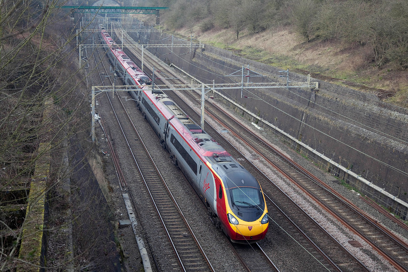 390126, VT 12.47 Liverpool Lime Street-London Euston, Roade Cutting 
 390126 'Virgin Enterprise' heads south through the impressive Roade Cutting forming the 12.47 Liverpool Lime Street to London Euston. Virgin's as-built livery for the Class 390s certainly lifts the otherwise drab and grey scene at the end of the winter. 
 Keywords: 390126 12.47 Liverpool Lime Street-London Euston Roade Cutting