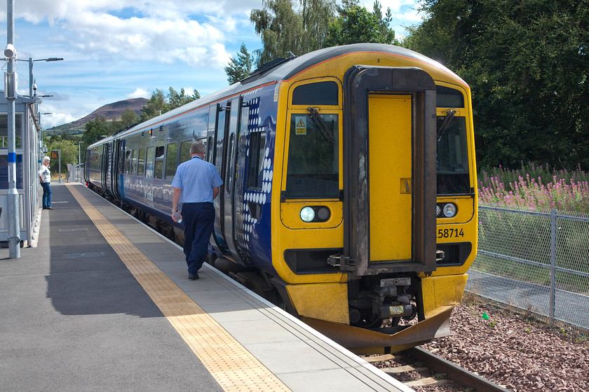 158714, SR 13.59 Tweedbank-Edinburgh Waverley (2T85), Tweedbank station 
 With the Roman fortified round hill known as Eildon Hill North in the background, 158714 waits to leave Tweedbank station with the 13.59 to Edinburgh Waverley. I took this train the short distance to Galashiels, the next station. Here, I alighted and spent a short while exploring the town and getting a spot of lunch. 
 Keywords: 158714 13.59 Tweedbank-Edinburgh Waverley 2T85 Tweedbank station