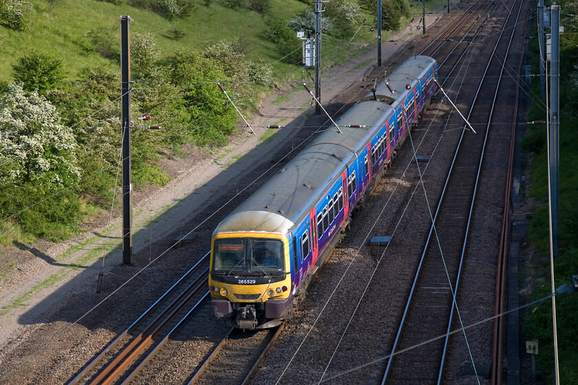 365529, FC 16.36 London King's Cross-Peterborough (2P24), New England bridge TL219796 
 365529 works the 2P24 16.36 King's Cross to Peterborough FCC service past New England bridge located between Huntingdon and Peterborough. The three-track arrangement on this section of the ECML, which actually is reduced to just two a few miles north of this location on the run into Peterborough, is a severe bottleneck. In this case, the Networker Express is on the down fast line. 
 Keywords: 365529 16.36 London King's Cross-Peterborough 2P24 New England bridge TL219796 First Capital Connect FCC