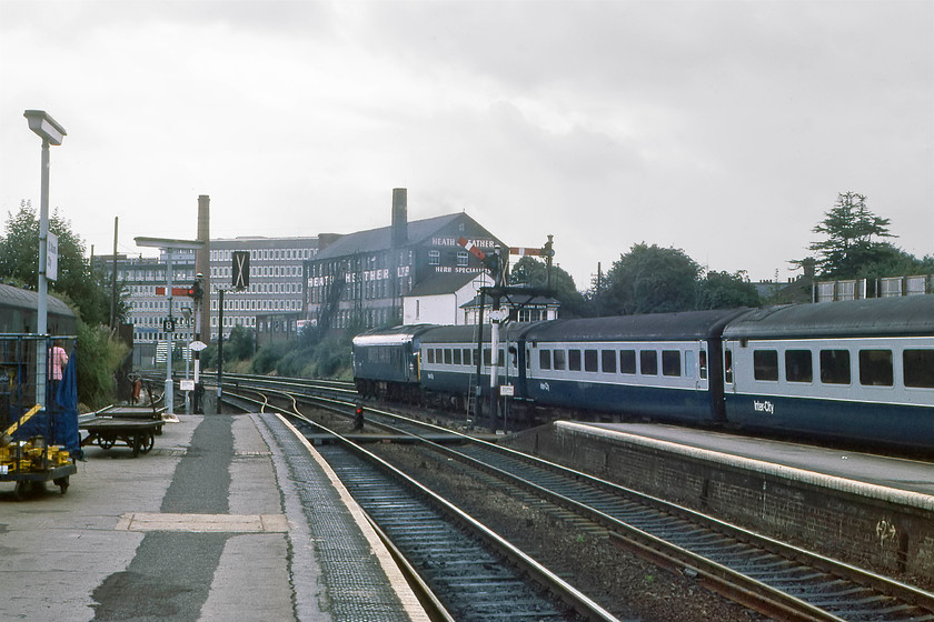 0009.-0045-0131,-0009.0040-Sheffield-London-St.-Pancras,-St.-Albans-Station 
 A picture taken by my travelling companion Graham shows 45131 leaving St. Albans with the 09.40 Sheffield to St. Pancras service. It is just passing in front of the signal box. Notice the large Heath and Heather warehouse beyond the station. This building was set up in 1920 by the company, which later became Holland and Barrett, to distribute their products by rail around the UK. And finally, yes that person in the distinctive red strippy shirt standing in front of the brute trolley to the left is a fifteen-year-old me! 
 Keywords: 45131 09.40 Sheffield-London St. Pancras St. Albans station