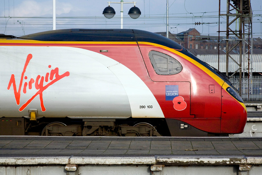 390103, VT 12.35 Manchester Piccadilly-London Euston (1A34), Manchester Piccadilly station 
 A side profile view of 390103 'Virgin Hero' waits at Manchester Piccadilly to leave with the 1A34 12.35 to London Euston. Notice that this particular Pendolino carries a poppy and is dedicated to The Royal British Legion. This is the 'as-built' livery that the class 390s have worn since their introduction in 2002. 
 Keywords: 390103 12.35 Manchester Piccadilly-London Euston 1A34 Manchester Piccadilly station