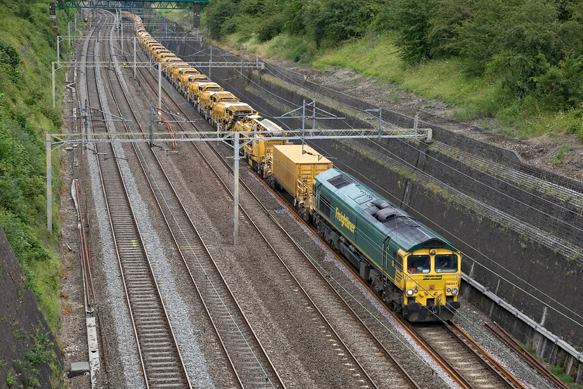 66547, 07.30 Birmingham lnternational-Willesden HOBC (6Y47), Roade cutting 
 The 07.30 Birmingham International to Willesden HOBC (High Output Ballast Cleaner) makes its way very slowly through Roade cutting with 66547 labouring at the front. This train dubbed the 'drain train', is used all over the network to remove ballast, clean it and return it in one fell swoop. 
 Keywords: 66547 07.30 Birmingham lnternational-Willesden HOBC 6Y47 Roade cutting Freightliner