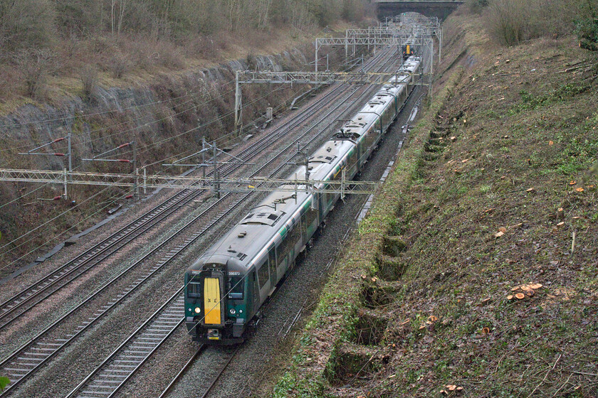 350373 & Class 350, LN 10.46 London Euston-Crewe (1U31, 2L) & Class 350s, LN 10.13 Crewe-London Euston (1U26, 2L), Roade cutting 
 With the West Coast Mainline shut for several days over the Christmas period contractors were brought into Roade cutting to undertake some much-needed vegetation clearance. With this new view now opened up following the clearance a pair of London Northwestern Desiros pass on the up and down fast lines. 350373 leads a classmate north on the 10.46 Euston to Crewe service whilst an unidentified pair head south with the 10.13 Crewe to Euston service. This view has revealed the buttresses that are built into the side walls of the cutting providing extra support for the vast brick retaining walls. 
 Keywords: 350373 Class 350 10.46 London Euston-Crewe 1U31 Class 350 LN 10.13 Crewe-London Euston 1U26 Roade cutting London Northwestern Desiro