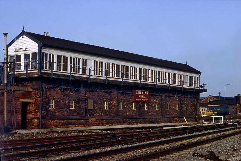 Chester No. 4 signal box (LNW, 1904) 
 In the fine evening sunshine, Chester No. 4 signal box is seen resplendent with its British Railways (Midland) enamel acting as a giant running-in sign for passengers. It was located just east of the station with the A56 Hoole Road bridge in the background. The box was another large LNWR structure with this example dating from 1904. It contained a large one hundred and seventy-six lever frame and was double manned. I suspect that BR was particularly pleased when it, and all the other mechanical boxes in the Chester area, was closed in early May 1984 with control moving to the PSB located on a piece of land to the east of the station near the No. 2 box. 
 Keywords: Chester No. 4 signal box LNWR 1904 number 4 no4