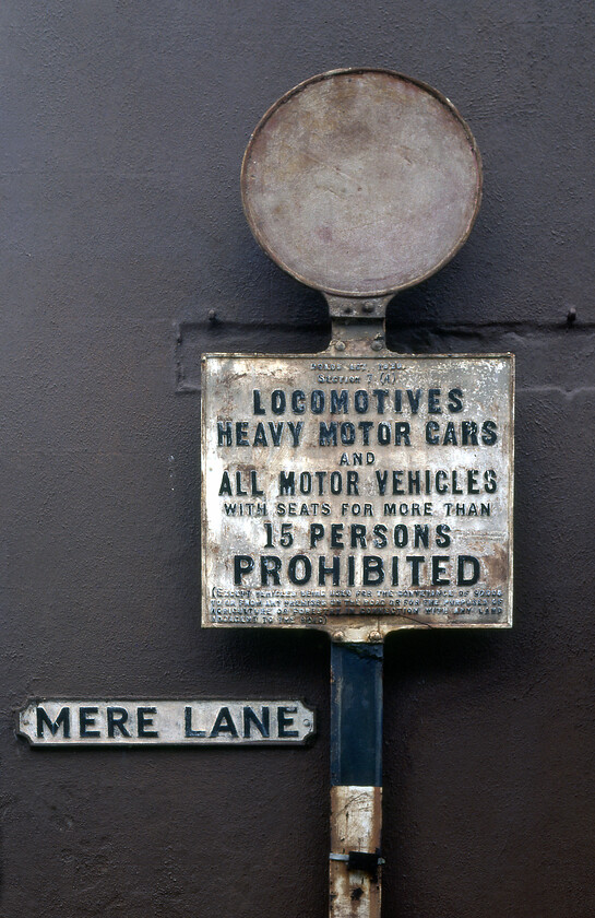 Cast street sign, Mere Lane Teignmouth 
 A superb example of a vintage piece of street furniture in Teignmouth. This cast sign in the town's Mere Lane will have dated from the start of the twentieth century with its placement precipitating the moving of the previous street sign looking at the recess in the stonework of the building behind that I believe today is the Thornhill Hotel. 
 Keywords: Cast street sign Mere Lane Teignmouth