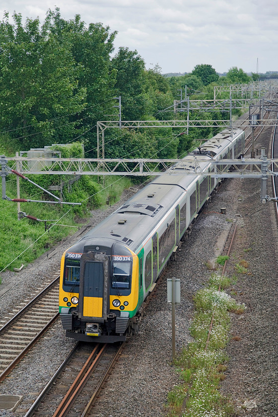 350374, LM 12.54 London Euston-Northampton (2N15, RT), Victoria Bridge 
 The class 350s were delivered in three batches new to the southern end of the WCML starting in 2005 replacing the class 321s. The first batch were 3501XXs, followed by the 3502XXs and finally in 2014 the 3503XXs were delivered. Here, one of that last batch, 350374 passes Victoria Bridge with the 12.54 Euston to Northampton. 
 Keywords: 350374 2N15 Victoria Bridge