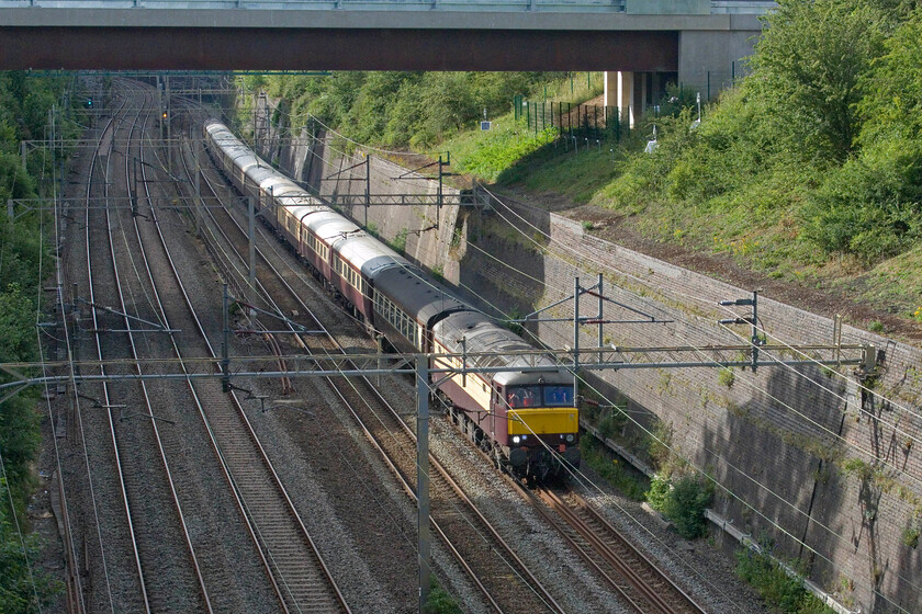 57601, 17.36 Wolverton Centre Sidings-Milton Keynes Central (via Northampton) (5Z29, 6L), Roade cutting 
 Passing under the new bridge that spans Roade cutting the 5Z29 17.36 Wolverton Centre Sidings to Milton Keynes empty coaching stock move is seen led by 57601 'Windsor Castle'. It would arrive at Milton Keynes a little late after a delayed departure from Wolverton but would be further held before heading south to London due to the coaches carrying the passengers from the Silverstone Grand Prix being caught up in the inevitable congestion as four hundred and eighty thousand racegoers attempted to leave the course! Apologies for the poor placing of the leading locomotive but I had to press the shutter a little earlier to capture the front in the evening sunshine. 
 Keywords: 57601 17.36 Wolverton Centre Sidings-Milton Keynes Central Northampton 5Z29 Roade cutting WCR Northern Belle Windsor Castle