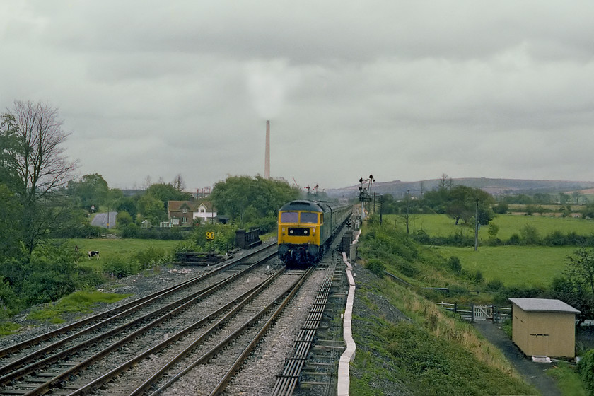 47499, 09.30 London Paddington-Penzance, Heywood Road Junction from the signal box 
 Taken from the window of Heywood Road Junction signal box, 47499 leads the 1B44 09.30 Paddington to Penzance. The train is about to rattle over the point work as it takes the Westbury cut-off as it continues its journey westwards. The 400 foot high Westbury cement works chimney dominates this scene. In September 2016, this chimney, that was part of the scenery of Wiltshire for over forty years, was demolished following the closure of the works in 2009. The class 47 did not live quite that long, after becoming 47709, exactly a year after this picture was taken, it went on to be become one of the short-lived Pullman machines being named Dionysos by Fragonset in 2001. Unfortunately, it became surplus to requirements and was stored eventually being cut up at Eastleigh in September 2012. 
 Keywords: 47499 09.30 London Paddington-Penzance Heywood Road Junction from the signal box