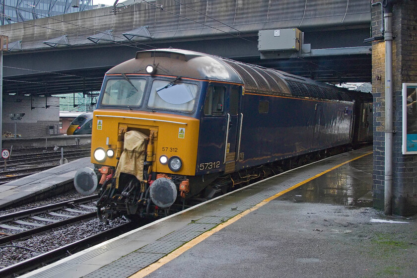 57312, 07.34 London Paddington-Reading Traincare Depot (5A50, 5L), London Paddington station 
 57312 departs from Paddington with the 5A50 07.34 empty sleeper stock to Reading Traincare Depot. With a forced seventy-mile return trip to Reading for servicing and stabling, this must surely affect the viability of the Great Western sleeper service. Also, I do not know if the loss of specialist facilities at the now closed Old Oak Common facility has contributed to recent severe unreliability issues forcing all sorts of emergency measures to keep the sleeper service in operation. 
 Keywords: 57312 07.34 London Paddington-Reading Traincare Depot 5A50 London Paddington station GWR Great Western Sleeper