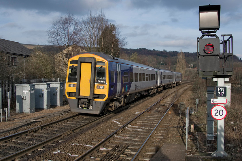 158758, NT 14.58 Manchester Victoria-Leeds (2E19, 2L), Todmorden station 
 With the relatively new signalling much in evidence on the right hand side of the picture, 158758 leaves Todmorden with the 2E19 14.58 manchester Victoria to Leeds. The late afternoon sunshine is really strong as the sun gets lower in the sky. It was a pleasant and warn afternoon, unusual for late February. 
 Keywords: 158758 14.58 Manchester Victoria-Leeds 2E19 Todmorden station