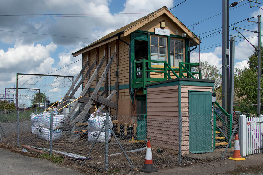 Littleport signal box (GE, 1882) 
 A signal box in peril! When I last visited Littleport signal box it had the timber supports to the rear but in a further effort to prevent its collapse, it now has huge bags of ballast attached to the timberwork. Indeed at the time of our visit, a team from Network Rail were examining the internals of the box and ticking a lot of boxes on some paperwork on their clipboards! The box, that controls the level crossing on the busy former A10 road (that now bypasses the small town) was due to close in 2021 with control moving to the Romford RSC. However, this appears to have been delayed but perhaps the box will colapse before it is officially closed! 
 Keywords: Littleport signal box GE Great Eastern Railway