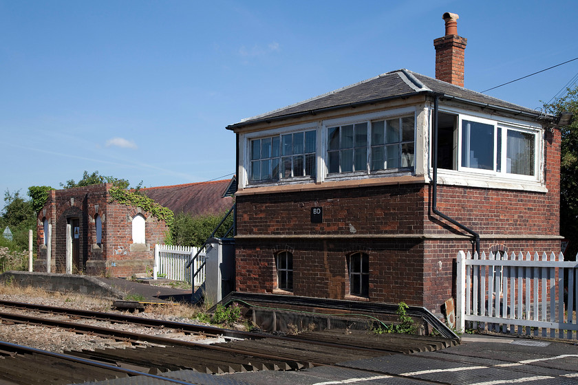 Bromfield signal box (LNW & GW Joint, 1873) 
 Another of the LNW and GW Joint boxes that are found on the Welsh Marches line. Bromfield was opened in 1873 and is just adjacent to a race course. The remains of the old station building are seen to the left, closed 09.06.58. My shot taken on 01.08.81 is taken in exactly the same position as this, not a great deal had changed down to the same picket fencing, see..... https://www.ontheupfast.com/p/21936chg/30033442597/x4-bromfield-signal-box-lnw-gw-joint 
 Keywords: Bromfield signal box