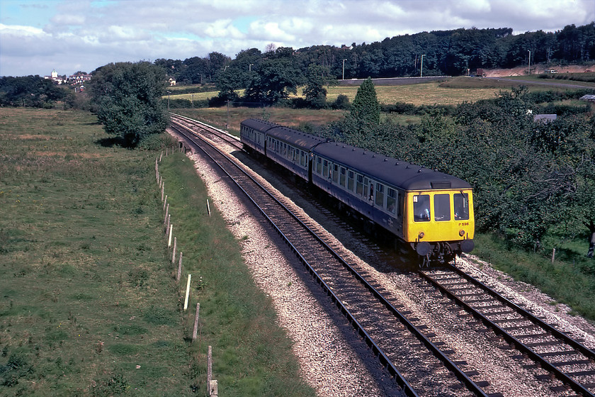 W51099, W59416 & W51076, 11.25 Exeter St. Davids-Paignton, Aller SX875689 
 The 11.25 Exeter St. David's to Paignton service approaches Aller bridge on a quiet Sunday lunchtime. The Class 119 set number P596 has just passed Aller Junction, indeed the signal box can be seen in the distance to the top left just below St. Luke's church tower. While a photograph from this exact position is still possible today the scene is totally different with a number of roads associated with the A380 relief road now crisscrossing the background with the railway disappearing into a short tunnel just behind the large tree on the left that has unfortunately been cut down. 
 Keywords: W51099, W59416 & W51076, 11.25 Exeter St. Davids-Paignton, Aller SX875689