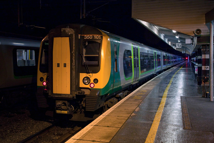 350101, stabled, Northampton station 
 350101 sits stabled at Northampton's platform three awaiting its next duty. Next to it in Riverside sidings another 350 waits for the morning commute next day. 
 Keywords: 350101 stabled Northampton station