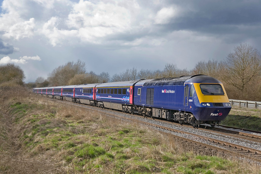 43164, GW 14.00 Bristol Temple Meads-London Paddington (1A20), Baulking SU324904 
 Just to the east of the village of Baulking in west Oxfordshire, a footpath follows a track parallel to the GWML. For a short distance, it is right next to the line only separated by a fence that recently has been renewed. This location provides very open views of the line both to the east and the west. With a very dramatic sky in the background, 43164 leads the 14.00 Bristol Temple Meads to Paddington past this spot. Unfortunately, this superb location will be ruined in the coming months as the electrification masts obliterate the view. 
 Keywords: 43164 14.00 Bristol Temple Meads-London Paddington 1A20 Baulking SU324904